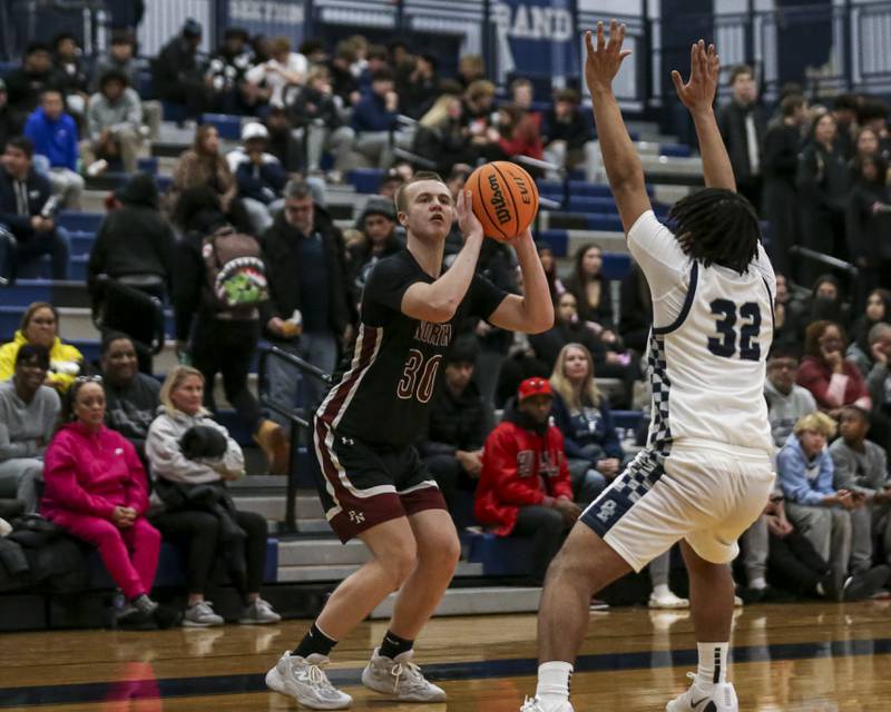 Plainfield North's Carson Miller (30) sizes up a shot during their basketball game between Plainfield North at Oswego East Friday, Dec 5, 2025 in Oswego.