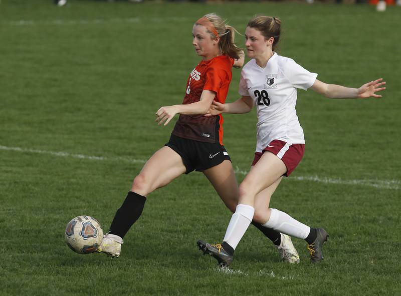 Crystal Lake Central's Carter Thompson takes a shot on goal as she is defended by Prairie Ridge's Olivia Roth during a Fox Valley Conference soccer match Tuesday, May 10, 2022, between Crystal Lake Central and Prairie Ridge at Crystal Lake Central High School.