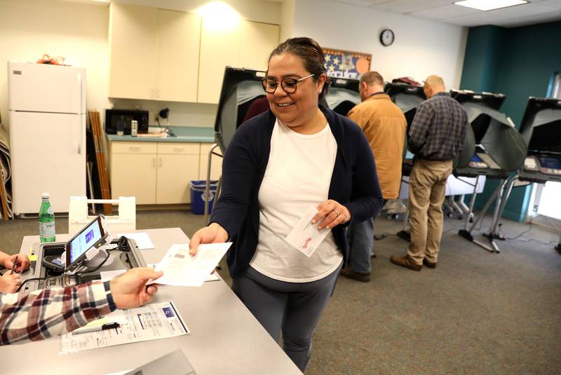 Pilar Van Dusen is assisted before voting at the Town and Country Library in Elburn for the General Election on Tuesday, Nov. 8, 2022.