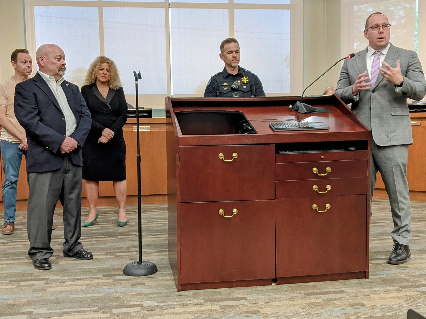 Oswego Village President Ryan Kauffman, far right, honors Ron Elvin, far left, for his 10 years of service on the Oswego Police Commission during the May 27 Oswego Village Board meeting.