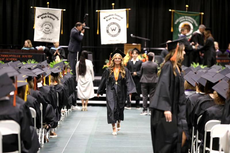 Brooke Ittersagen walks down the aisle during the Wheaton Warrenville South commencement ceremony on Saturday, May 24, 2025 at the College of DuPage in Glen Ellyn.