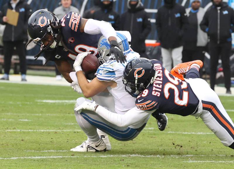 Chicago Bears linebacker Tremaine Edmunds (49) and cornerback Tyrique Stevenson (29) wrap up Detroit Lions tight end Sam LaPorta during their game Sunday, Dec. 10, 2023 at Soldier Field in Chicago.