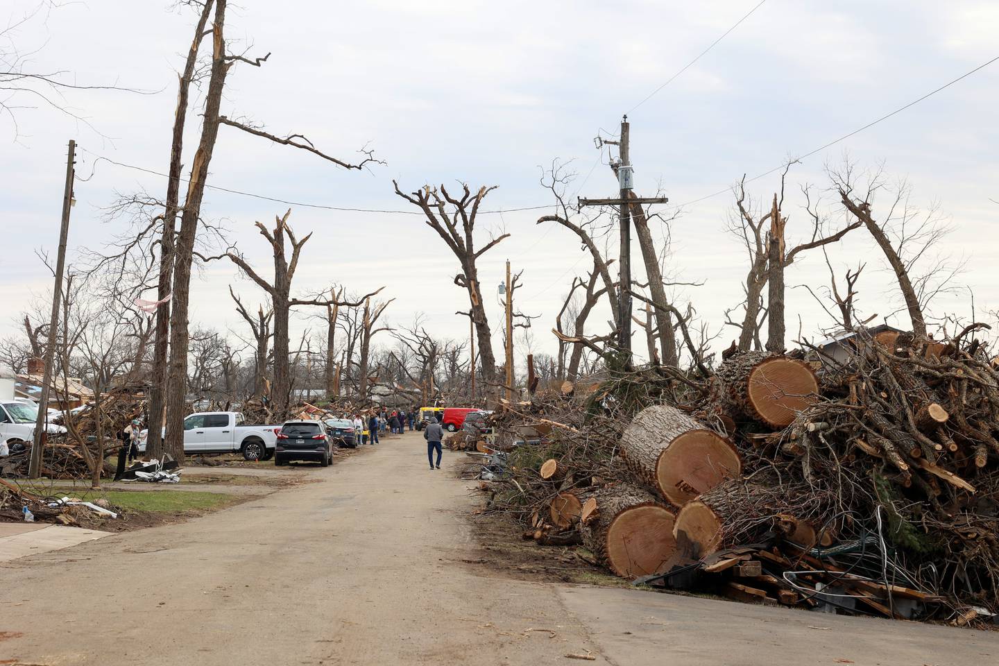 Debris is piled high along Elmwood Drive in Aroma Township on March 14, 2026, as crews worked to clean up following the March 10 tornado in Kankakee County.