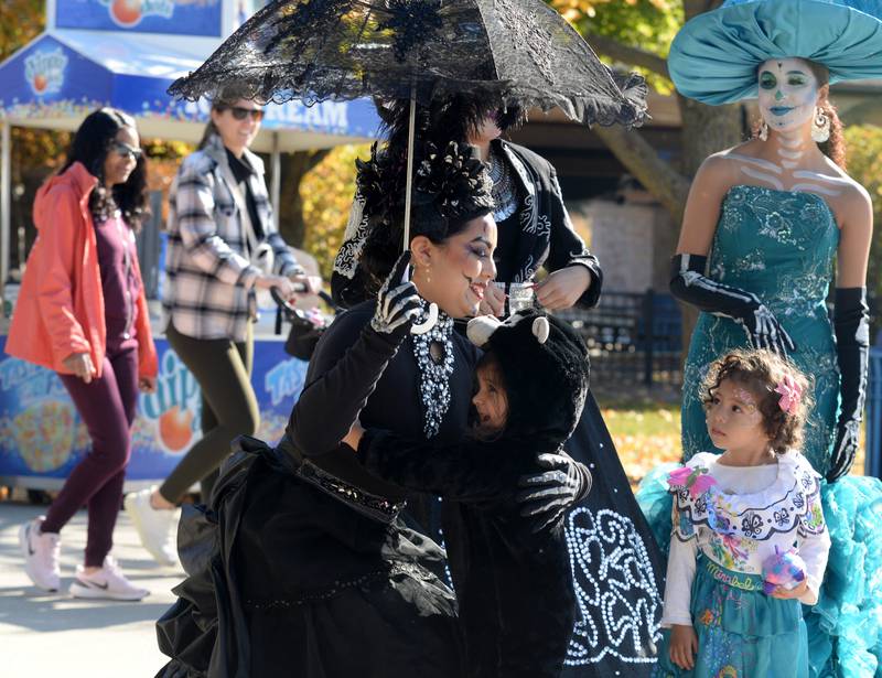 Children including (left) Quinn Gonilla and Paola Beaz of Chicago react to seeing Day of the Dead ladies including Jacqueline Martinez, Melissa Lopez and Luisanna Lopez during the event held at Brookfield Zoo Friday Oct 29, 2022.