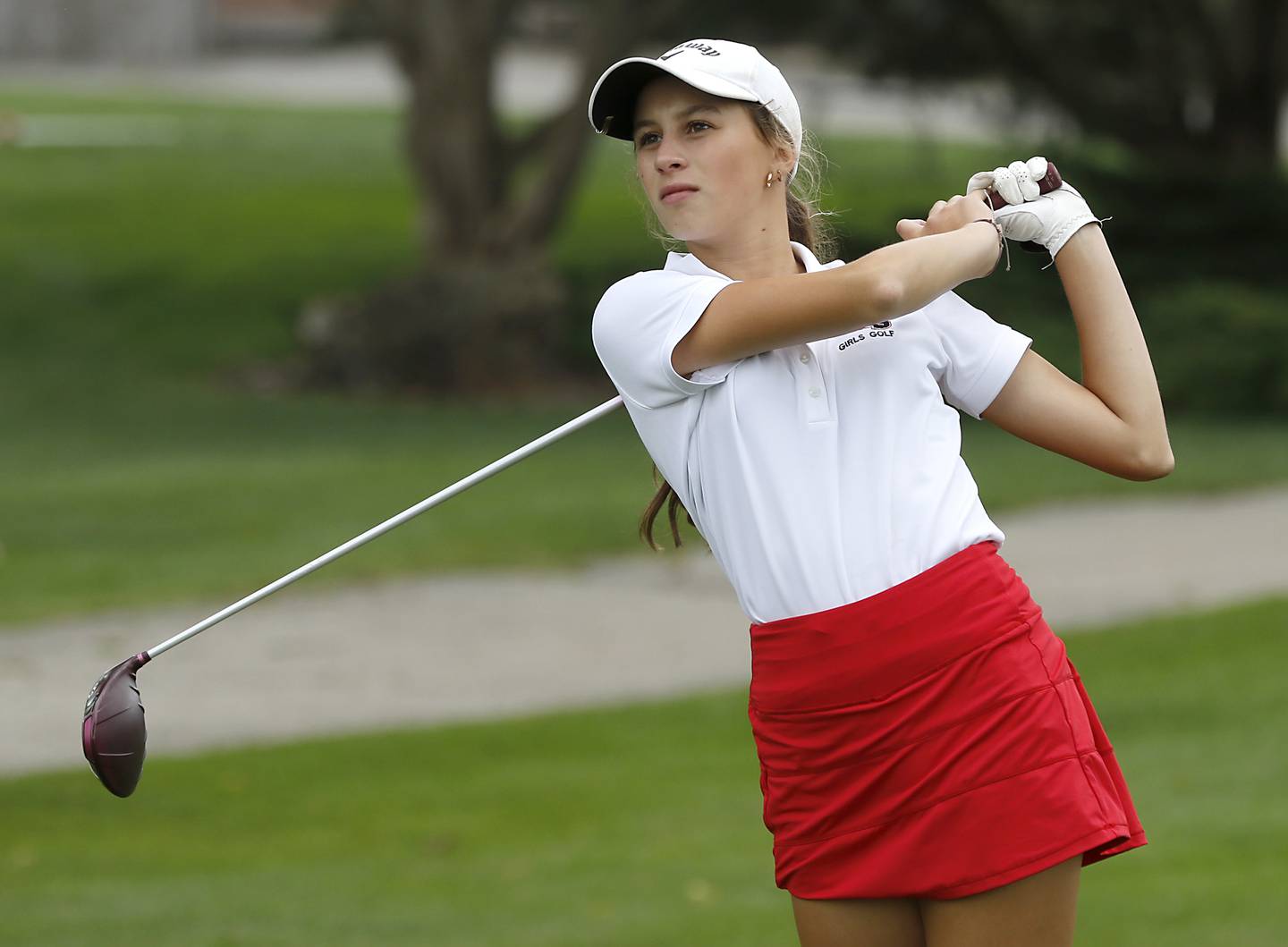 Huntley’s Kinsey Hayes watches her tee shot on the 1st hole during the Fox Valley Conference Girls Golf Tournament Wednesday, Sept. 24, 2025, at Crystal Woods Golf Club in Woodstock.
