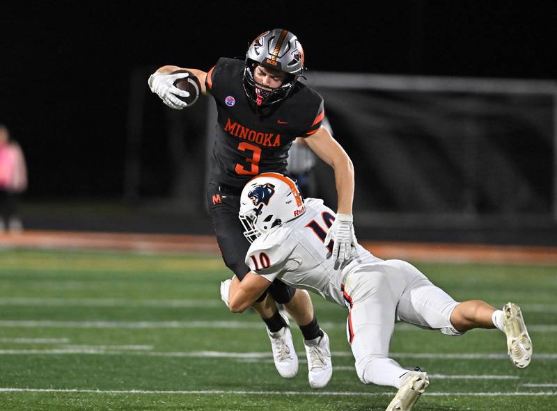 Minooka's Brady Hairald (3) gets tackled by Oswego's MARIANO VELASCO (10) during the conference game on Friday, OCT. 10, 2025, at Minooka.