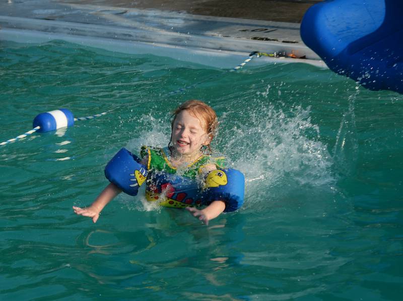 Robyn Roe, 5, of Polo, closes her eyes as she slides into the Polo Pool on Thursday, Aug. 24, 2023. The pool was open from 5-8 p.m. during the recent hot spell to give people a place to cool down.