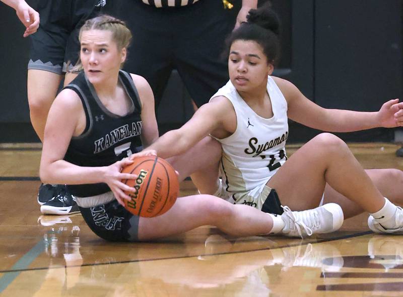 Kaneland's Brigid Gannon and Sycamore's Monroe McGhee go after a loose ball during the Class 3A regional final game Friday, Feb. 17, 2023, at Sycamore High School.