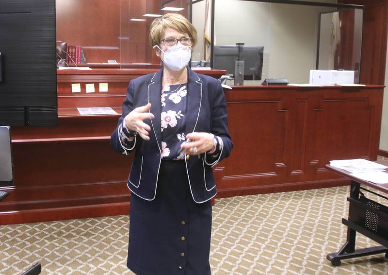 DeKalb County Judge Robbin Stuckert talks Thursday about the the new look in the courtroom at the DeKalb County Courthouse that will be used for jury trials when they resume as COVID-19 restrictions are eased. The new setup includes multiple plexiglass dividers between court members and personal plexiglass booths for each juror.