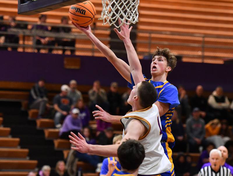 Lyons Township’s Tommy Sloan lays the ball up over Downers Grove North’s Colin Doyle during a game on January 15, 2026 at Downers Grove North High School in Downers Grove .