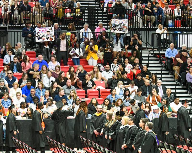Friends and family hold signs and record video of their senior graduates on Saturday, May 24, 2025, during the Class of 2025 Commencement ceremony held at the NIU Convocation Center in DeKalb.