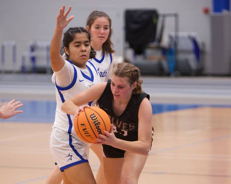 Prairie Ridge's Emily McPherson looks to make a pass past St. Charles North's Lelanie Posada at the Burlington Central Tournament on Tuesday, Nov. 19,2024 in Burlington.