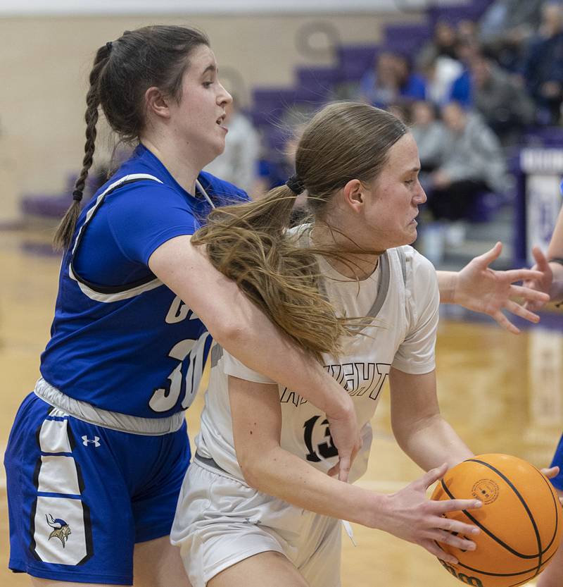 Kaneland’s Grace Brunscheen works while being guarded by Geneva’s Keira McCann Monday, Feb. 16, 2026, in the Class 3A regional semifinals.