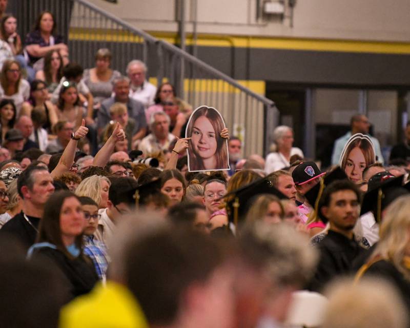 Attendees show their support for their graduates by holding up posters and a thumbs-up during the Class of 2026 Commencement on Sunday, May 24, 2026, held at Sycamore High School.