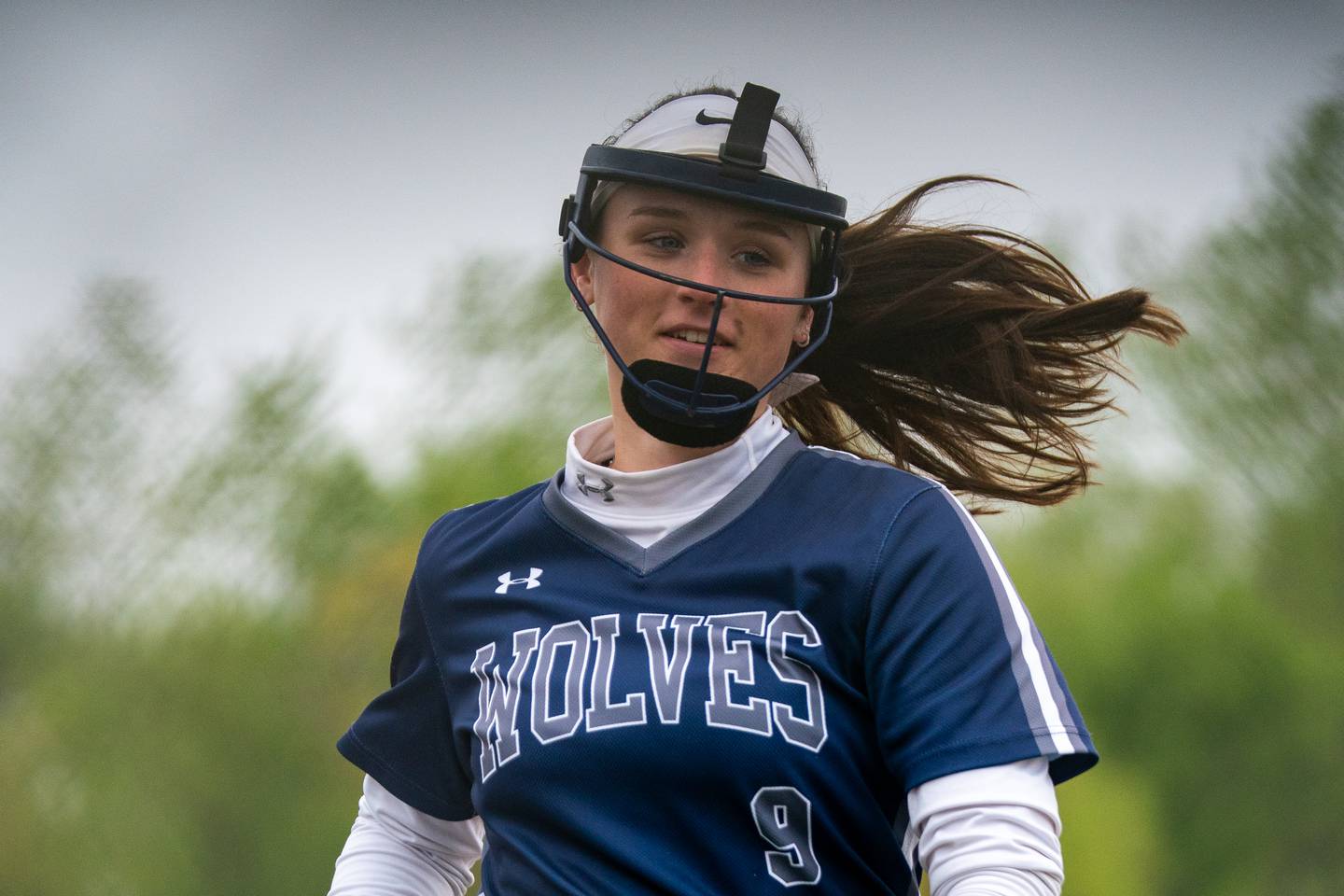 Oswego East's Kenzie Gatz (9) smiles after ending the inning with a strike out against West Aurora during a softball game at Oswego East High School on Monday, May 8, 2023.