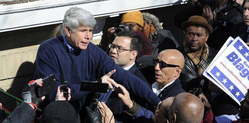 Former Gov. Rod Blagojevich, pictured with Mark Vargas to his left in eyeglasses, makes his way through the crowd after a news conference Wednesday at his Chicago home, a day after getting out of prison through a commutation by President Donald Trump.