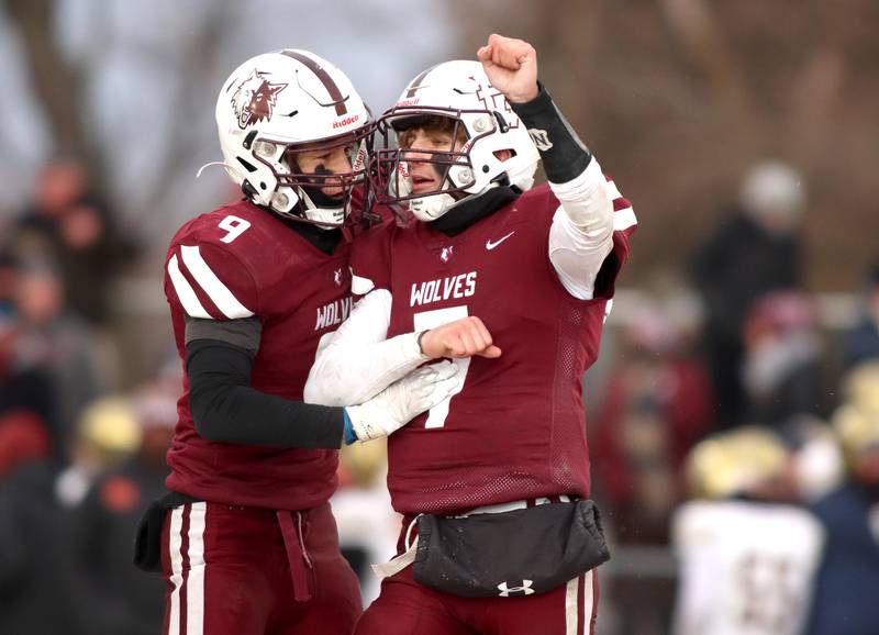 Prairie Ridge’s Joseph Vanderwiel, left, and Tyler Vasey celebrate a win over St. Ignatius in Class 6A football playoff semifinal action at Crystal Lake on Saturday.