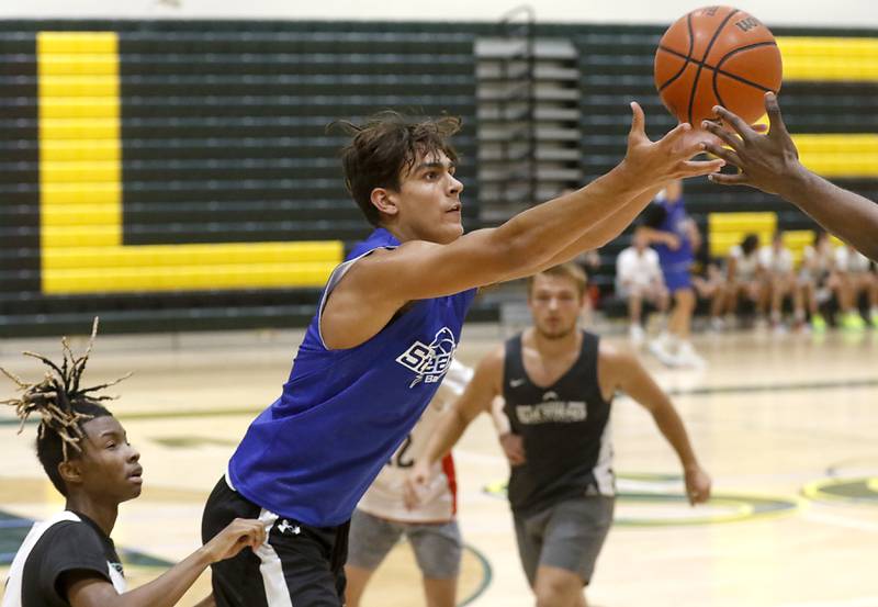 Woodstock's Spencer Cullum grabs the basketball during a game against Rockford East Friday, June 23, 2023, in the Crystal Lake South Gary Collins Shootout, at the high school in Crystal Lake.