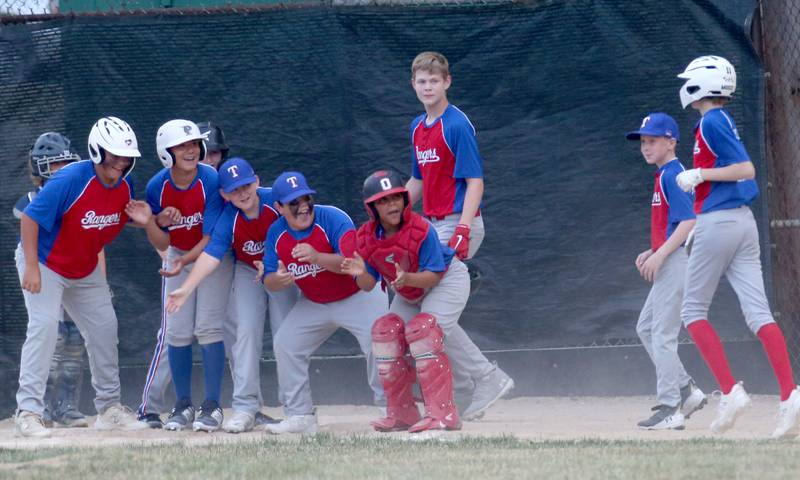 Members of the Frostbyte MSP Rangers react with teammate Mason Mucci after hitting a solo home run during the Ottawa Little League baseball (12U) City Championship on Friday, June 23, 2023 at Varland Park in Ottawa.