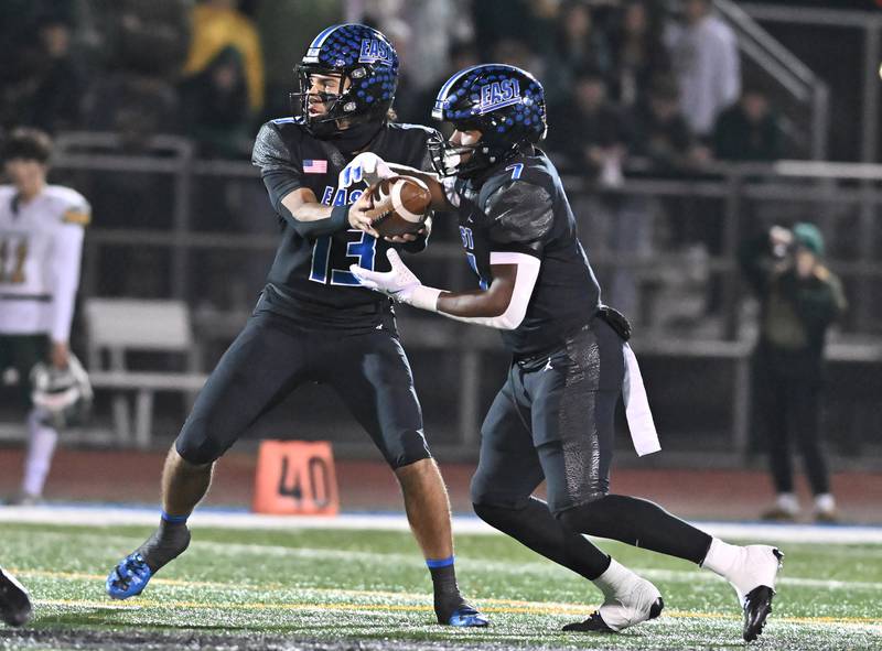 Lincoln-Way East's quarterback Jonas Williams (13) hands the ball off to Zion Gist during the IHSA Class 8A Quarterfinals game against Stevenson on Friday, Nov. 15, 2024, at Frankfort. (Dean Reid for Shaw Local News)