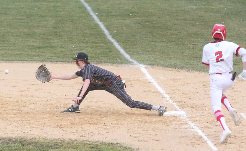 Hall's Izzaq Zrust stretches to catch the ball at first base to force out Streator's Zander McCloskey on Wednesday, March 13, 2024 at Kirby Park in Spring Valley.