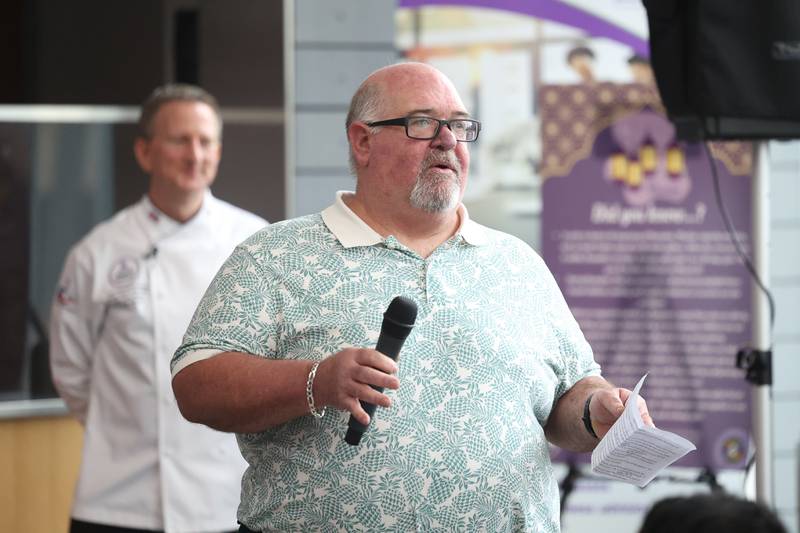 Mark Haller, Director at Illinois State Board of Education Nutrition Department, talks with high school students at a nutritional and wellness event hosted by Joliet Junior College on Friday, April 21, 2023 in Joliet.