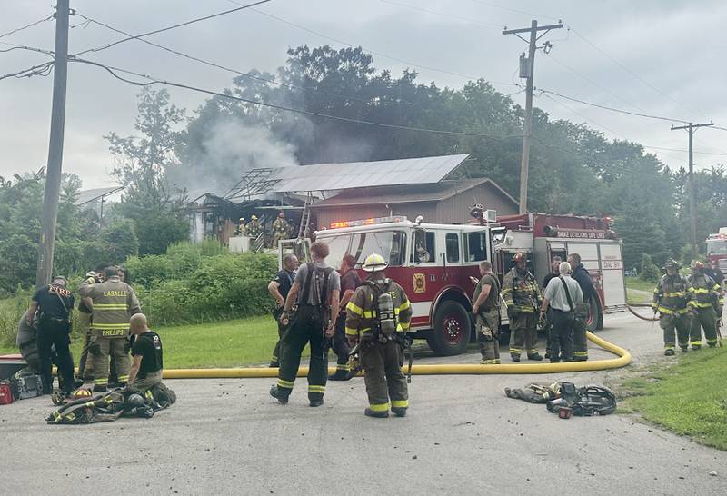 Dozens of firefighters respond to a fully-engulfed structure fire in the 500 block of North 2782nd Road on Monday, July 21, 2025 in La Salle. FIre departments from Utica, Wallace, Naplate, Spring Valley, Mendota, Troy Grove, La Salle, Peru, Oglesby and Tonica responded to the scene. Fire crews were dispatched at 9:45 a.m. La Salle Police and La Salle County Sheriff were also on the scene.