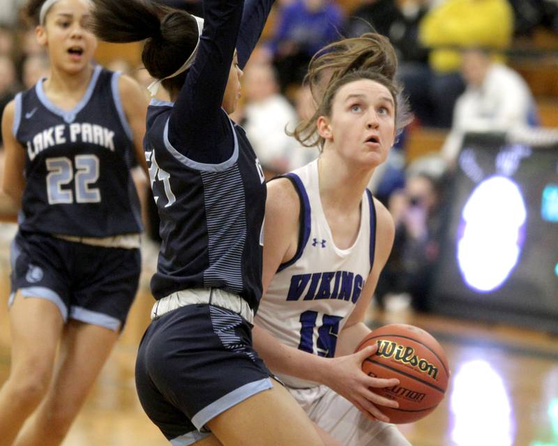 Geneva’s Cassidy Arni (right) tries to shoot the ball around Lake Park’s Gabi Burgess (left) during a Class 4A Glenbard West Sectional semifinal game in Glen Ellyn on Tuesday, Feb. 21, 2023.