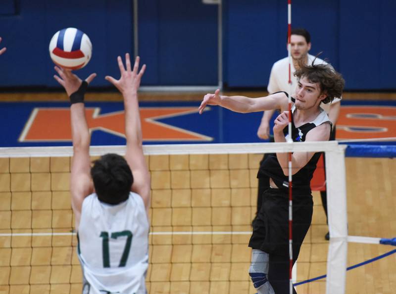 Paul Valade/pvalade@dailyherald.com
Lincoln-Way East's Tyler Walenga, right, hits into the Glenbard West defense during Saturday’s IHSA state boys volleyball championship match in Hoffman Estates.