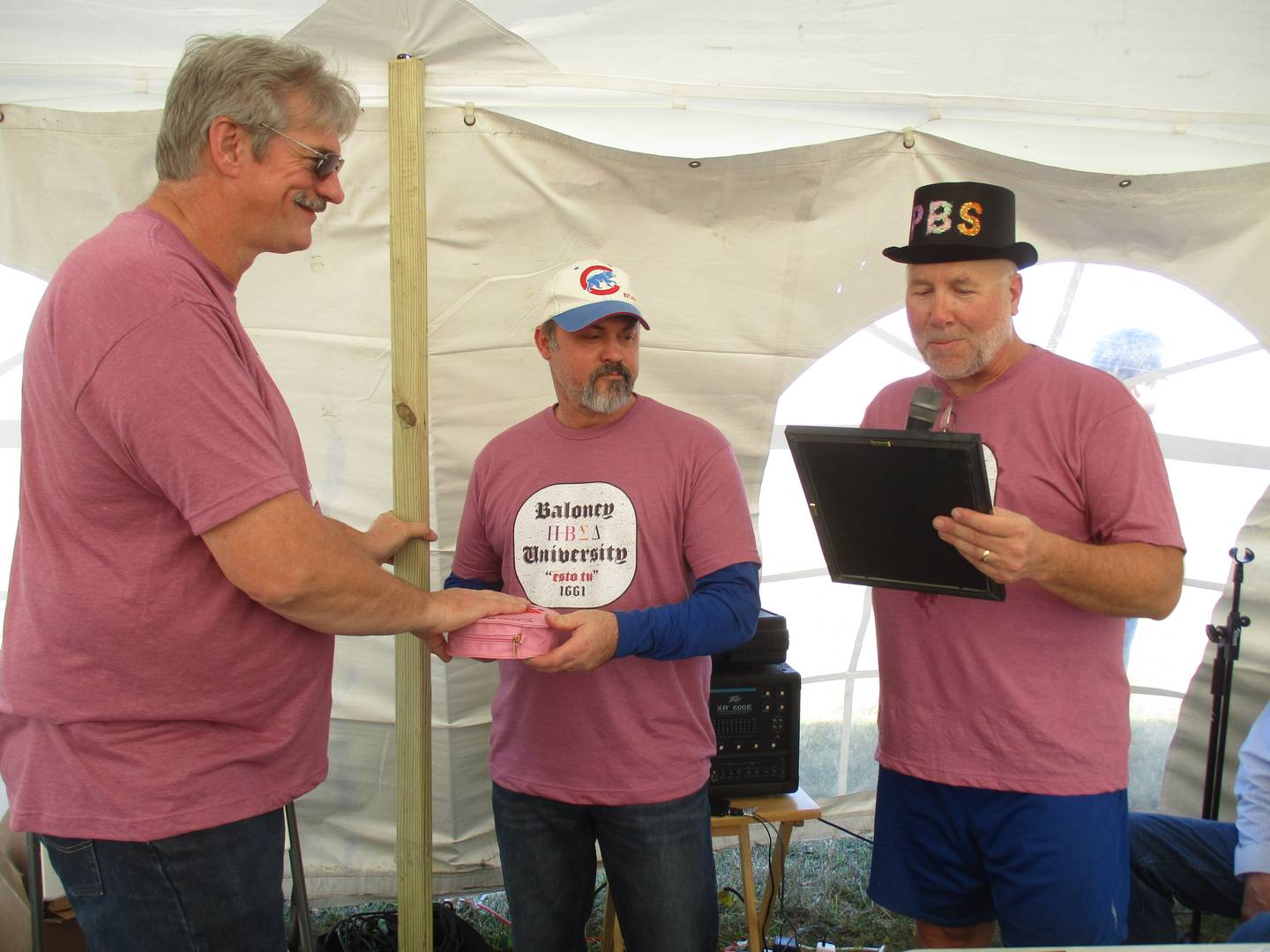 Harvest Chapel Food Pantry Director Jeff Ikemire of Sandwich, left, takes the oath of office as co-mayor of Bologna, Illinois as part of the annual Plano-Bologna-Sandwich Day event on Oct. 23, 2022. Event organizer Chris Schwemlein, right, performs the ceremony while Sandwich Mayor Todd Latham assists.