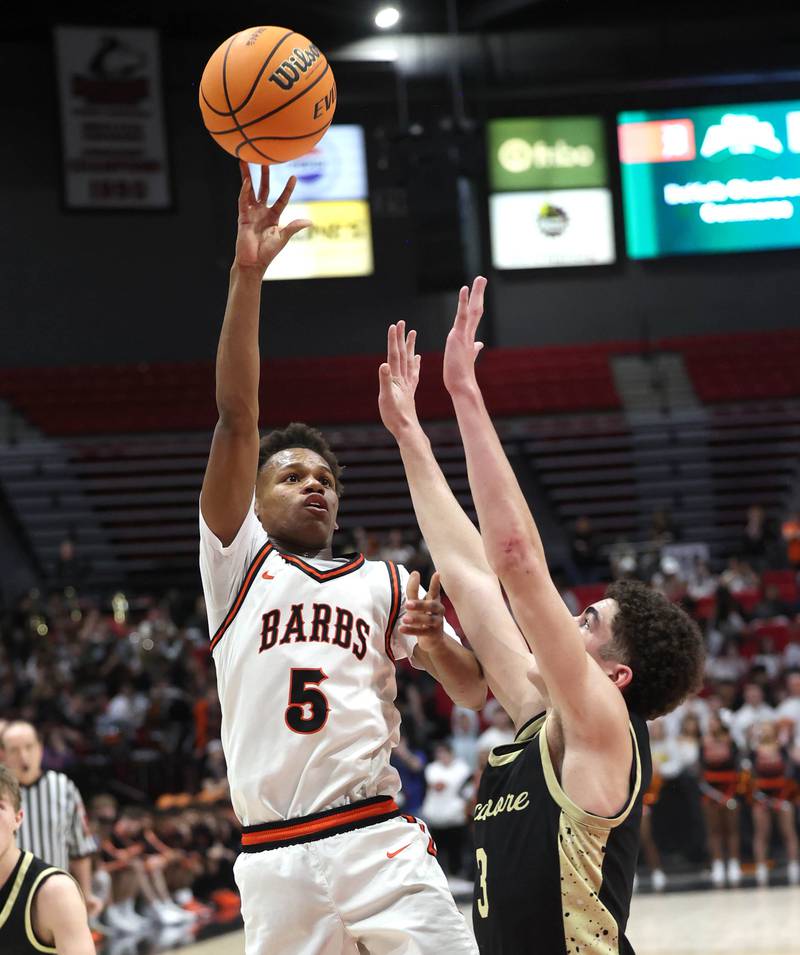 DeKalb's Bryan Miller shoots over Sycamore's Marcus Johnson Friday, Jan. 30, 2026, during the FNBO Challenge at the Convocation Center at Northern Illinois University in DeKalb.
