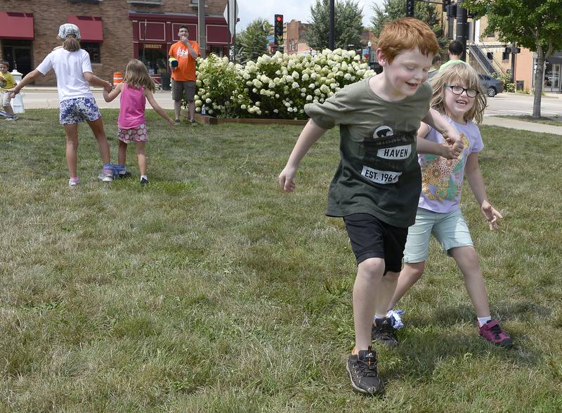 Nolan and Rocky Kennedy has some laughs as they compete Saturday, Aug. 6, 2022, in the three-legged race as part of Kid’s Play Day at the Jordan block in Ottawa.
