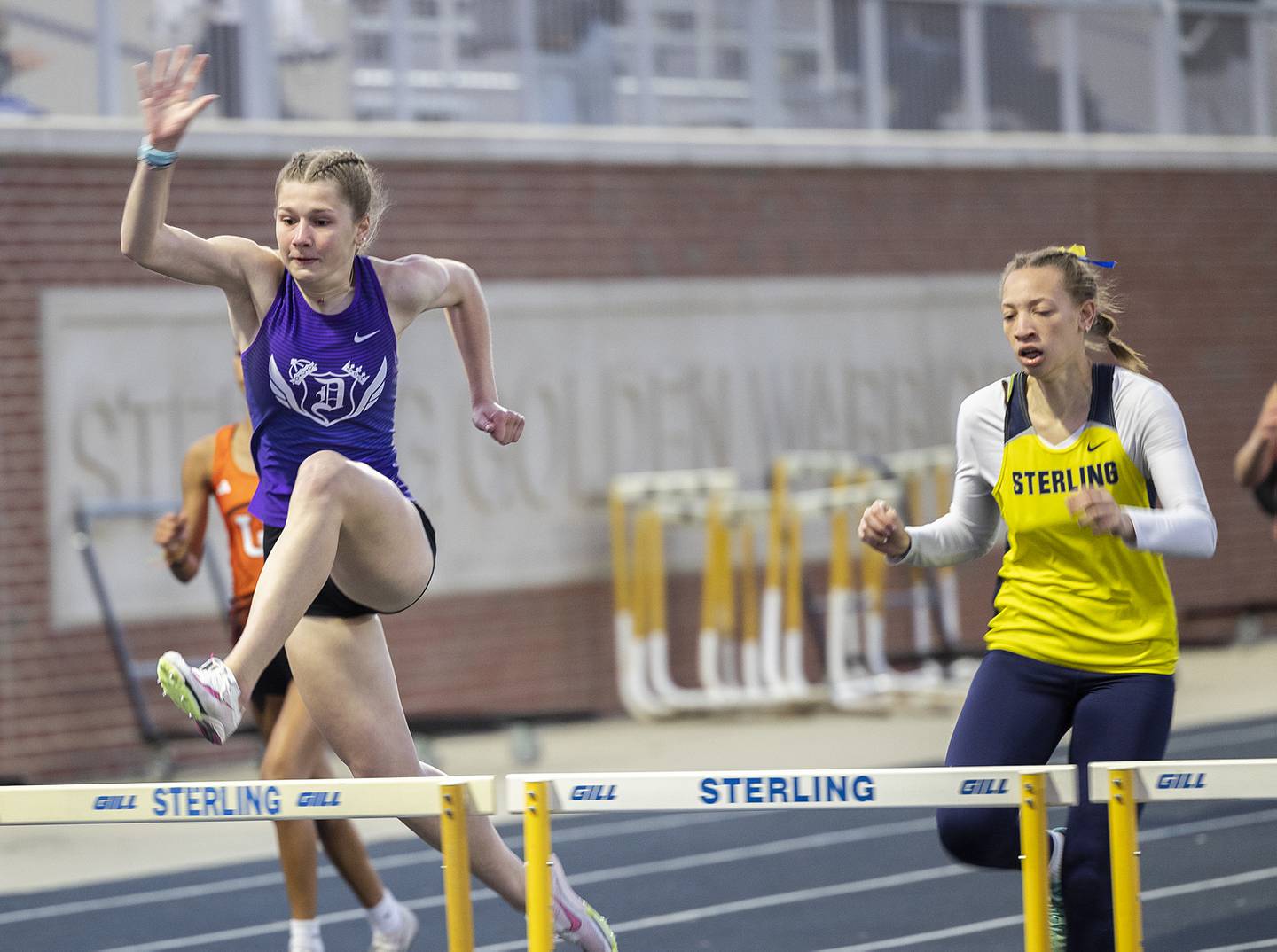 Dixon’s Teyla Wendt clears the final hurdle in the 300 Thursday, April 25, 2024 at the Sterling High School Night Relays.