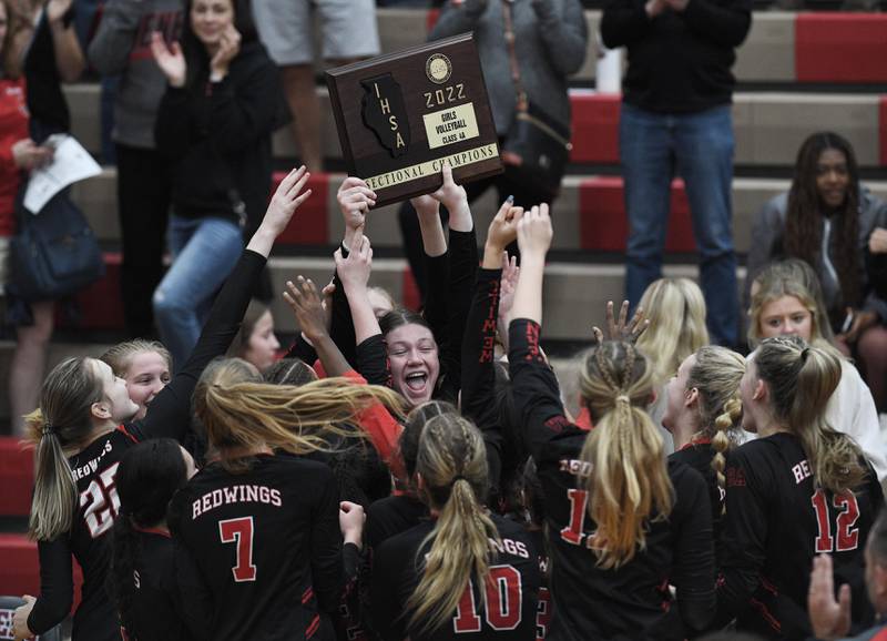 John Starks/jstarks@dailyherald.com
Benet’s Annie Eschenbach holds the championship trophy as her teammates swarm around her after they defeated Naperville North in the Class 4A Sectional championship match in Plainfield on Wednesday, November 2, 2022.