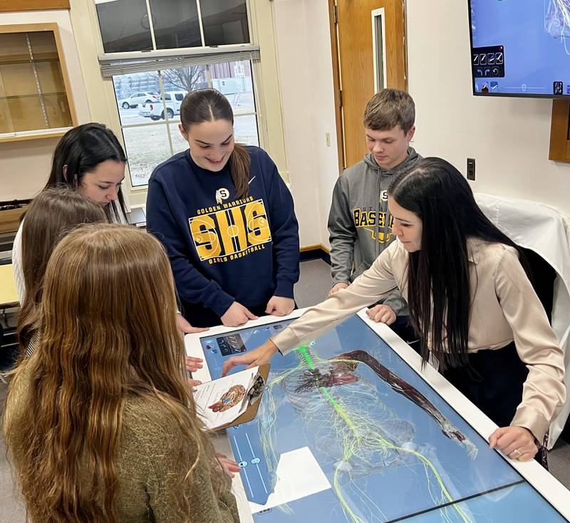 Sterling High School teacher Nicole Schlemmer and students Alivia Ruffin, Chloe Clark, Adamari Gutierrez, Kate Austin and Nick Capp use the school's 3-D anatomage table.