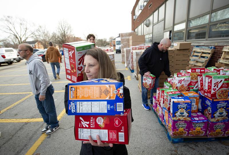 Gena Gregoire, teacher at Lincoln Cultural Center, unpacks boxes of donated cereal during a donation drive by Convoy of Hope at Lincoln Cultural Center in Kankakee on Thursday, March 12, 2026.