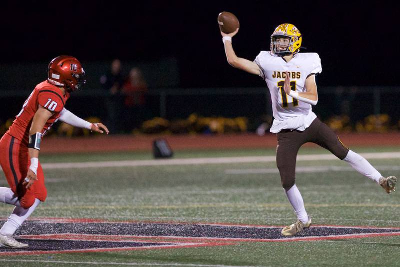 Jacob's Max Benner makes the pass for a gain against Huntley on Friday, Sept. 23,2022 in Huntley.