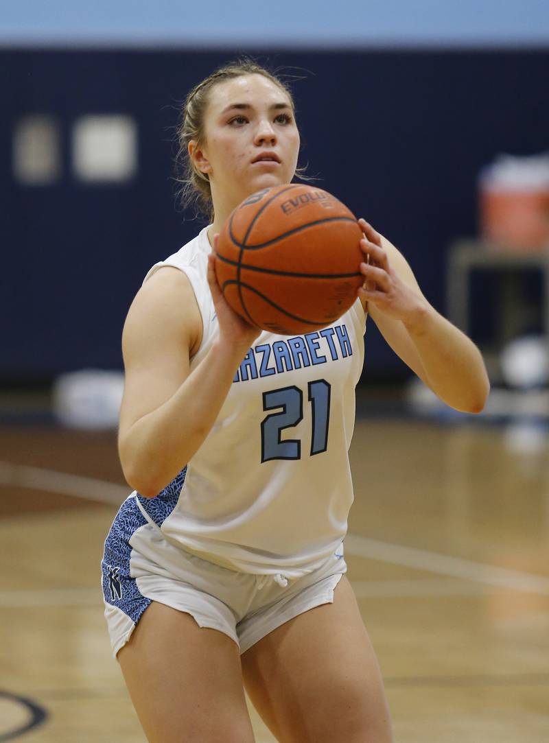 Nazareth's Olivia Austin (21) takes a free throw during the girls varsity basketball game between Carmel High School and Nazareth Academy on Wednesday, Dec. 7, 2022 in LaGrange, IL.