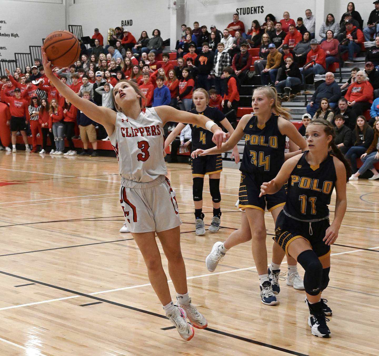 Amboy's Elly Jones (3) secures a rebound as Polo's Courtney Grobe (11), Sydnei Rahn (34) and Camrynn Jones (4) look on during their 1A regional final Friday night in Amboy.