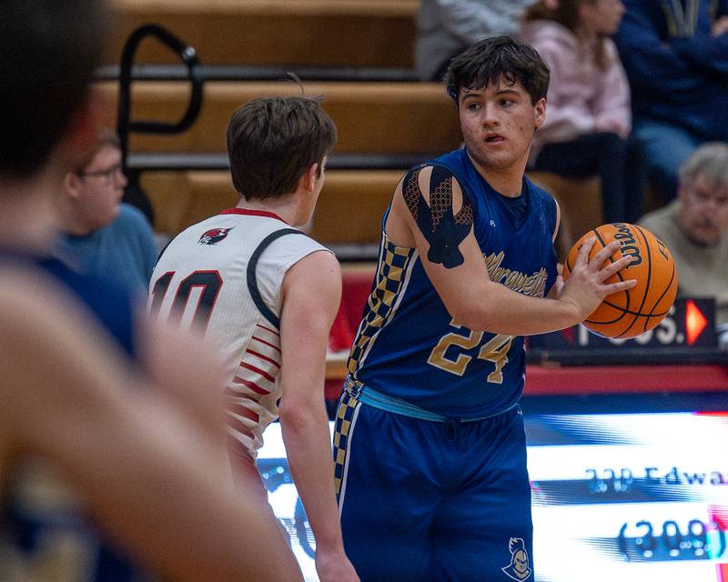 Marquette's Matt Graham (24) holds ball as Henry-Senachwine's Wyatt Wealer (10) guards on Friday, Feb. 13, 2026 at Henry-Senachwine High School in Henry.
