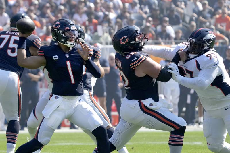 Chicago Bears quarterback Justin Fields passes behind the block of guard Lucas Patrick on Denver Broncos defensive tackle D.J. Jones during the first half, Sunday, Oct. 1, 2023, in Chicago.