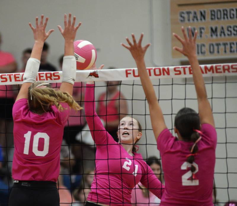 Eastland's #21 tries to spike over Fulton blockers Averi Bush (10) and Chloe Wilkin (2) during a Tuesday, Oct. 7, 2025 match in Fulton.