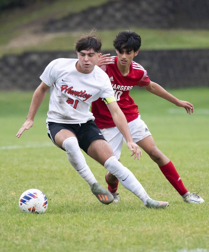 Huntley's Zach Heitkemper keeps the ball away from Dundee-Crown's Miguel Pena during their game on Thursday, October 6, 2022 at Dundee-Crown High School in Carpentersville. Dundee-Crown won 1-0.