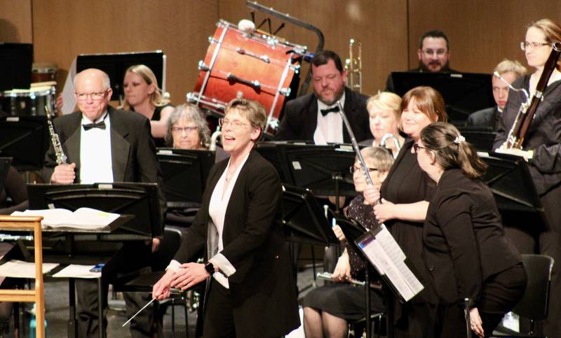 Conductor Annette Hackbarth of Dakota acknowledges the woodwinds section during audience applause after the opening number of the Sterling Municipal Band's Spring Concert on Wednesday at Centennial Auditorium.