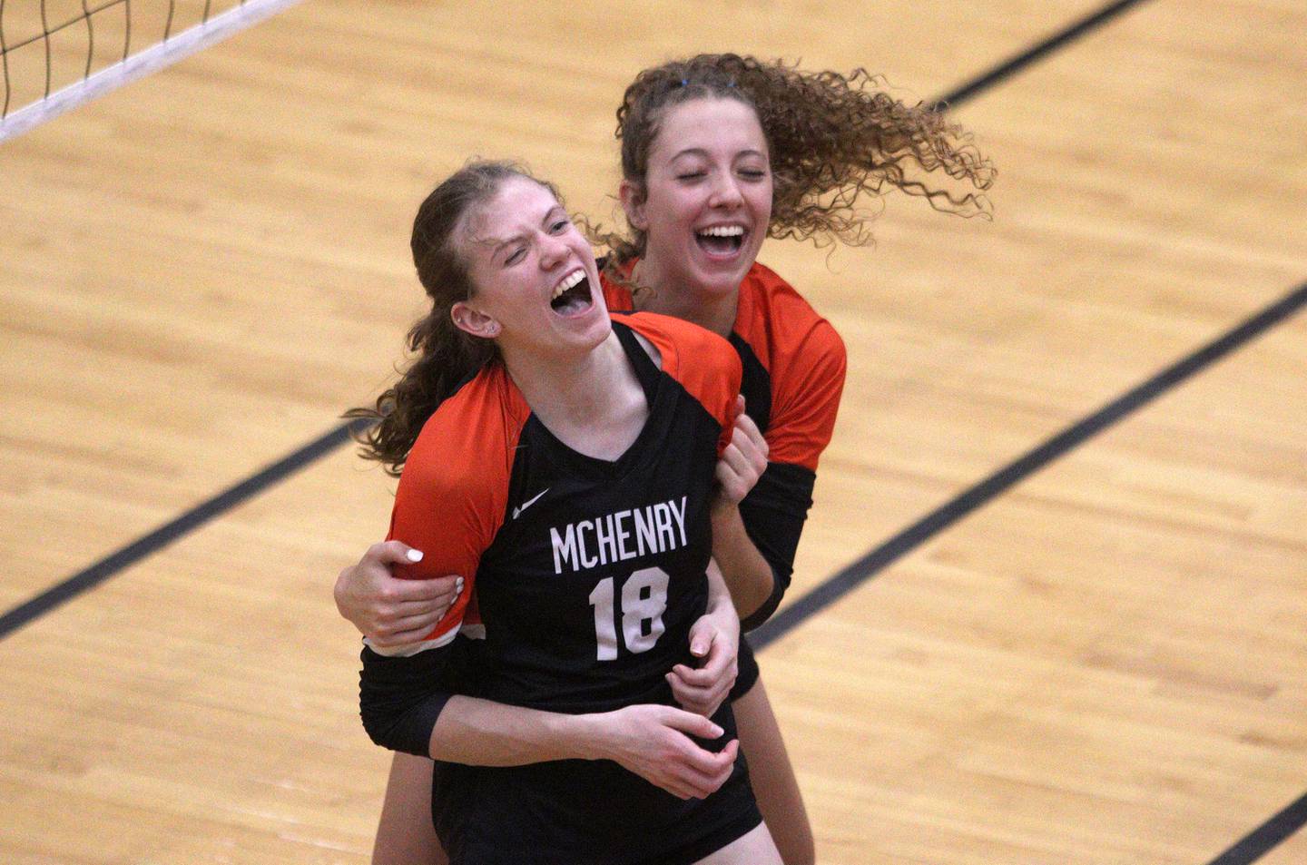 McHenry’s Sophie Zieba, back, and Ella Boland celebrate a three-set win over Prairie Ridge in varsity girls volleyball at McHenry Thursday.