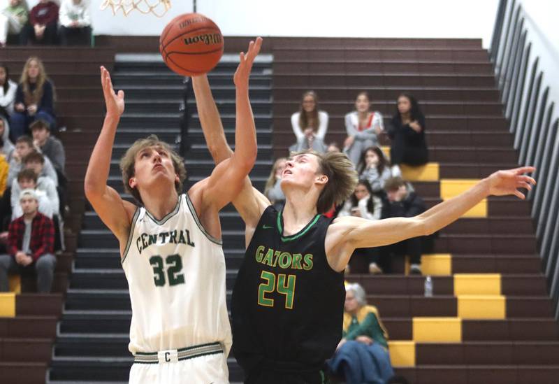 Crystal Lake South’s James Carlson, right, battles Grayslake Central’s Dennis Estepp during Hinkle Holiday Classic Basketball Tournament title game action at Jacobs High School Friday.