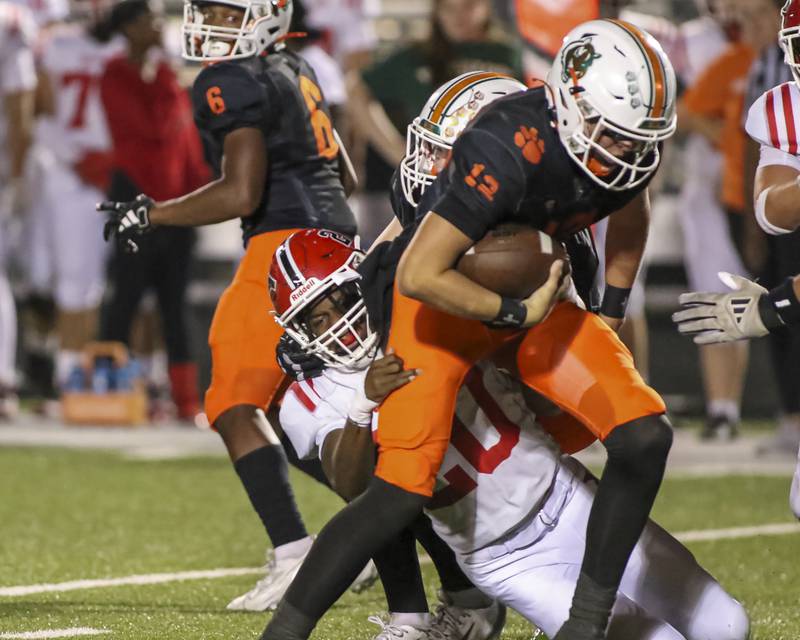 Yorkville's Tyvon Wilson (20) sacks Plainfield East's Brady Cloherty (12) during football game between Yorkville at Plainfield East Friday, Sept 19, 2025 in Plainfield.