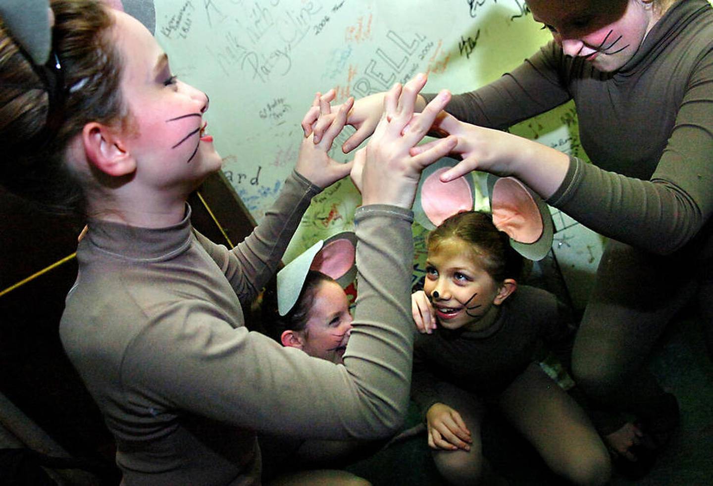 Helena Whitmore (left), 10, of Shorewood; Katie Shipley (right), 10, of Naperville; and Andrea Weyneth (bottom),10, of Naperville, play as they wait to go onstage during a dress rehearsal for Von Heidecke's Chicago Festival Ballet's 2007 production of "The Nutcracker" at the Rialto in Joliet.