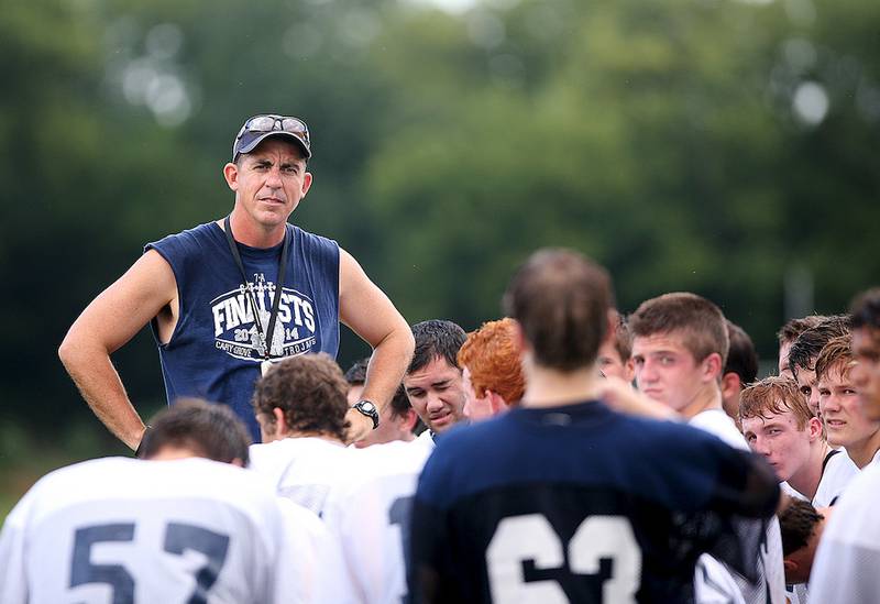 Coach Brad Seaburg talks to the team during football practice Aug. 10 at Cary-Grove High School in Cary.