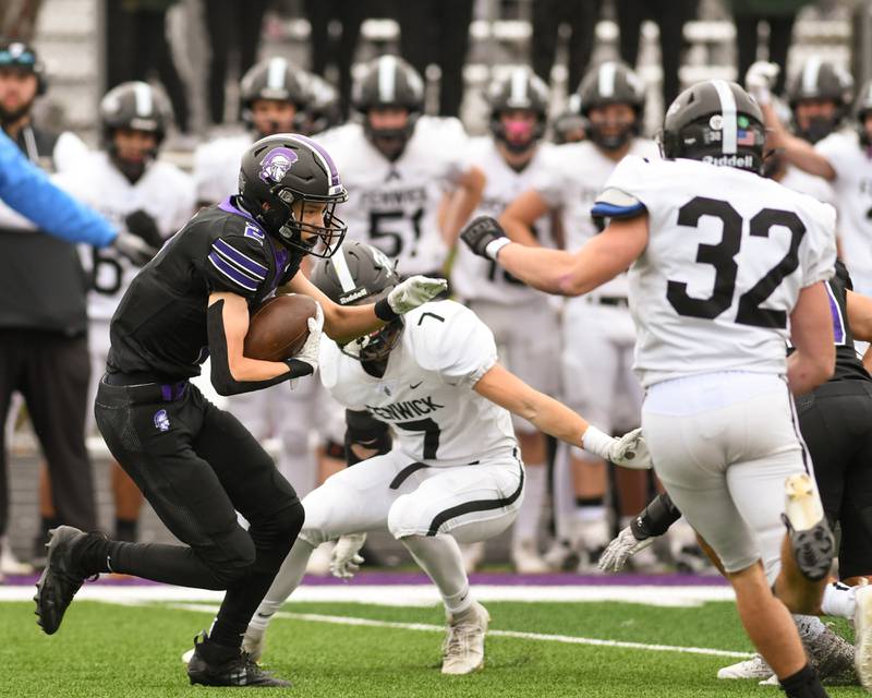 Downers Grove North's Alec Fiermuga, left, tries to maneuver around Fenwick’s defenders during the second week of the class 3A game on Saturday Nov. 9, 2024, held at Downers Grove North High school.